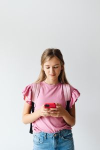 Kaboompics - Teenage Girl Texting on Red Smartphone