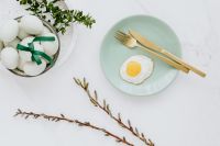 Kaboompics - Easter flat lay with green eggs and fried egg on a plate