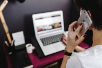 Kaboompics - Close-Up of Woman on a Phone Call Beside an Open MacBook