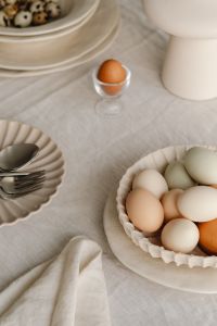Kaboompics - Pastel Easter Eggs In Ceramic Bowl On Linen