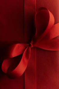 Kaboompics - Close Up Burgundy Ribbon Knot on Gift Wrap
