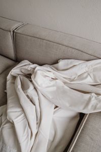 Kaboompics - White Linen Folds on Neutral Sofa – Fujifilm X100VI