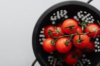 Kaboompics - Cherry Tomatoes in Colander with Copy Space for Recipe Design