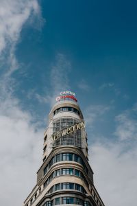 Kaboompics - Low-Angle Madrid Capitol Building with Schweppes Sign Beneath Blue Sky