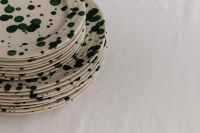 Kaboompics - Green Splatter Plate Stack with Linen Copy Space