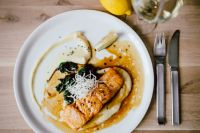 Kaboompics - Top View of Bourbon Glazed Salmon with Lemon Wedge and Silver Cutlery on Wood