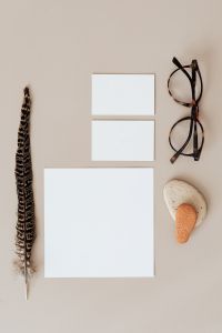 Kaboompics - Blank Branding Card Mockup with Glasses and Decorative Feather