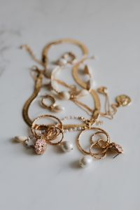 Kaboompics - Gold jewellery on white marble - necklace, bracelets, earrings