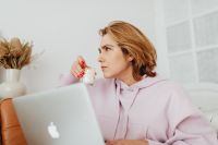 Kaboompics - Woman Working on a Laptop with a Candle at Home