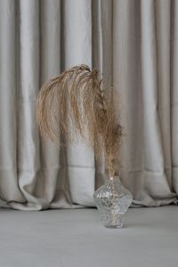 Kaboompics - Dried Palm Leaf in Textured Glass Vase on a Neutral Floor