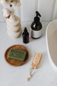 Kaboompics - Amber Oil Bottles and Cream Ceramic Decor on a White Bathroom Vanity, Clean Beauty Product Styling