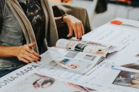 Kaboompics - Creative Designer Reviewing Magazine Cutouts on Brainstorming Table