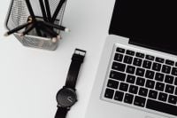 Kaboompics - Black Wristwatch, Laptop Keyboard and Pencil Cup on White Desk