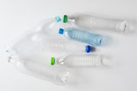 Kaboompics - Five Empty Plastic Bottles Scattered on White