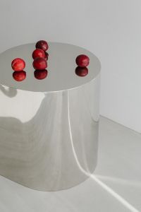 Kaboompics - Red Plums on Reflective Chrome Pedestal