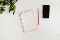 Kaboompics - Clipboard on a marble table, a mobile phone and a pencil, copy space