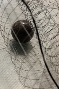 Kaboompics - Dark Marble Sphere and Wire Grid Background