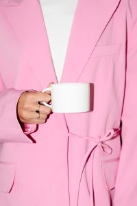 Kaboompics - Person in Pink Suit Holding a White Coffee Mug