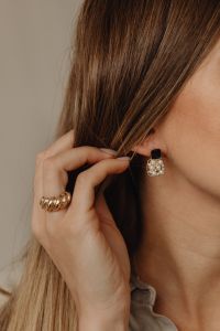 Kaboompics - Black and Gold Drop Earring on Woman's Ear