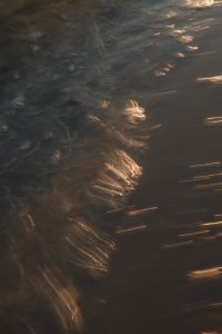Kaboompics - Dark Water Texture with Golden Sunset Light Streak
