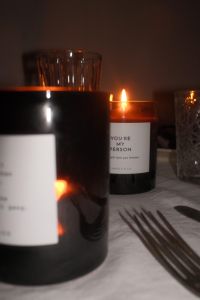 Kaboompics - Two Burning Amber Candles on Dinner Table