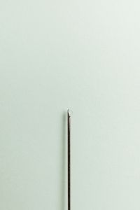 Kaboompics - Medical Needle Close-Up on a Minimal Mint Background