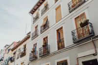 Kaboompics - White Madrid Apartment Facade with Wrought-Iron Balconies and Window Shutters