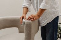 Kaboompics - Woman Brushing a Boucle Chair with a Small Cleaning Brush