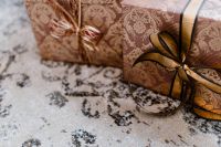 Kaboompics - elegantly wrapped gifts with golden ribbon