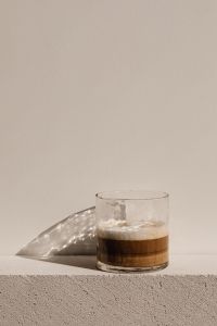Kaboompics - Glass Espresso Cup on a Beige Plinth with Large Copy Space