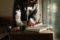 Kaboompics - Open Book and Green Smoothie on a Wooden Table