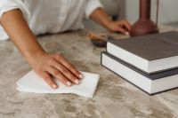 Kaboompics - Hand Wiping a Marble Coffee Table