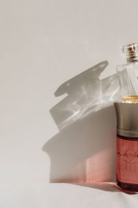 Kaboompics - Red and Clear Perfume Bottles with Cast Shadows
