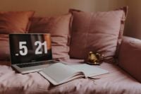 Kaboompics - Laptop, Open Book and Coffee in a Cozy Sofa Workspace