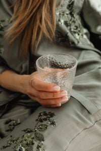 Kaboompics - Close-Up of a Textured Glass in a Woman’s Hand During a Home Break