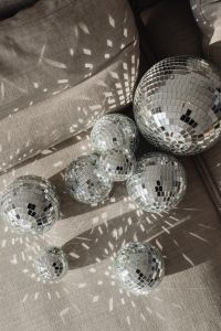 Kaboompics - Small Disco Balls Grouped on a Textured Gray Sofa Cushion