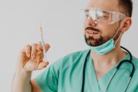Kaboompics - Doctor Preparing Syringe in Protective Gloves
