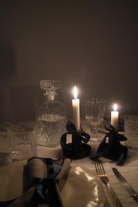 Elegant Candlelit Table Setting with Crystal Glassware & Satin Bows