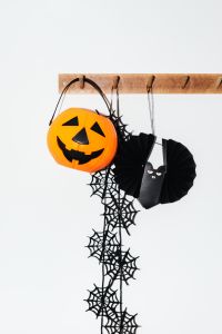 Kaboompics - Halloween Pumpkin Bucket with Spiderweb Garland and Paper Bat