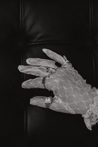 Kaboompics - Black-and-White Close-Up of Lace Gloves and Rings on a Leather Chair