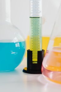 Kaboompics - Measuring Green Solution Beside Laboratory Glassware