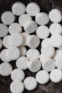 Kaboompics - White Round Tablets on a Dark Background
