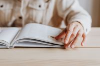 Kaboompics - Woman Turning Page in Open Book
