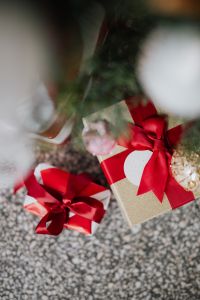 Kaboompics - Wrapped Presents beneath a Blurred Christmas Tree