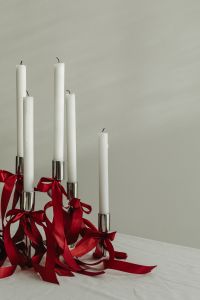 Kaboompics - White Taper Candles with Cascading Red Ribbons