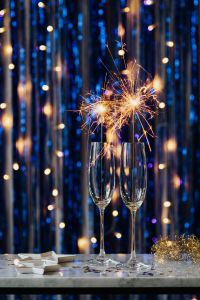 New Year's Eve Champagne and Sparkler Backgrounds with Blue Bokeh