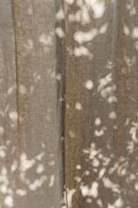Kaboompics - Warm Taupe Linen Curtains with Dappled Sunlight
