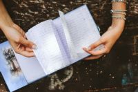 Kaboompics - Woman reading a diary by a table