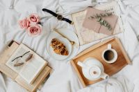 Kaboompics - Overhead Bedside Coffee and Pastry Flat Lay with Books, Pink Roses and Glasses