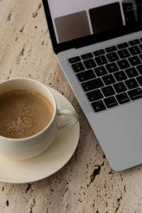 Minimalist Coffee Cups and Laptop on Travertine Table